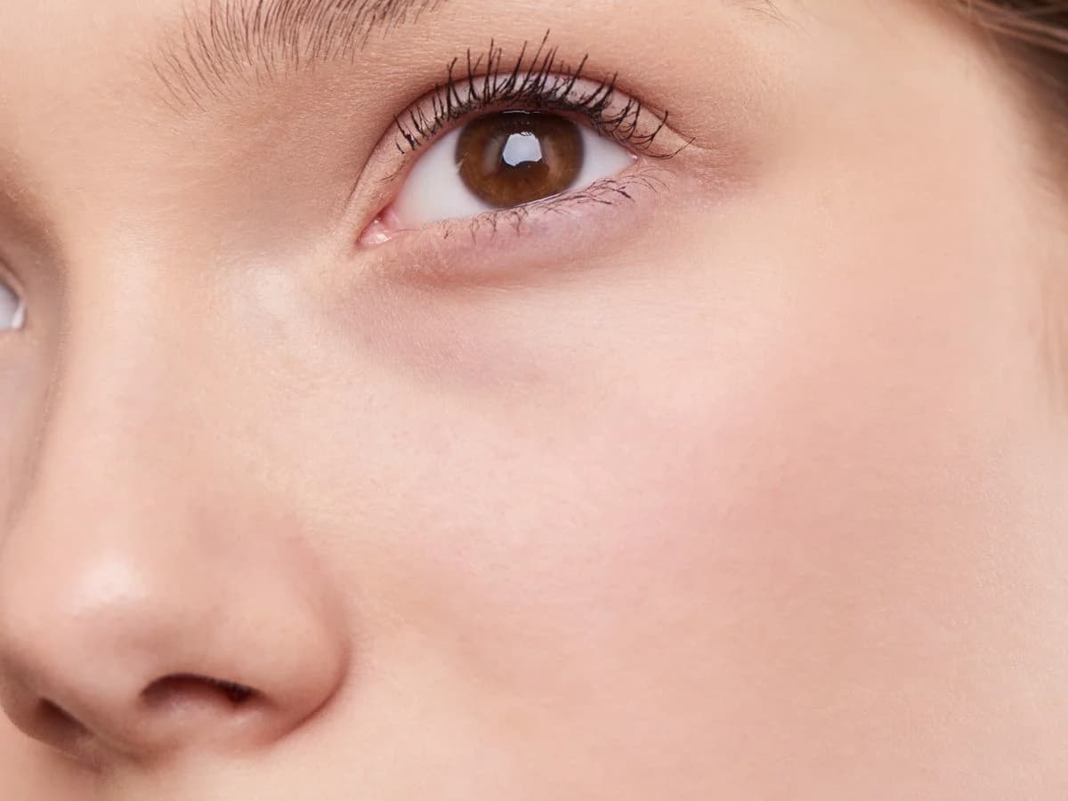 Close-up of bright, even, radiant skin after treatment — illustrative. TODO: replace with consented client photo